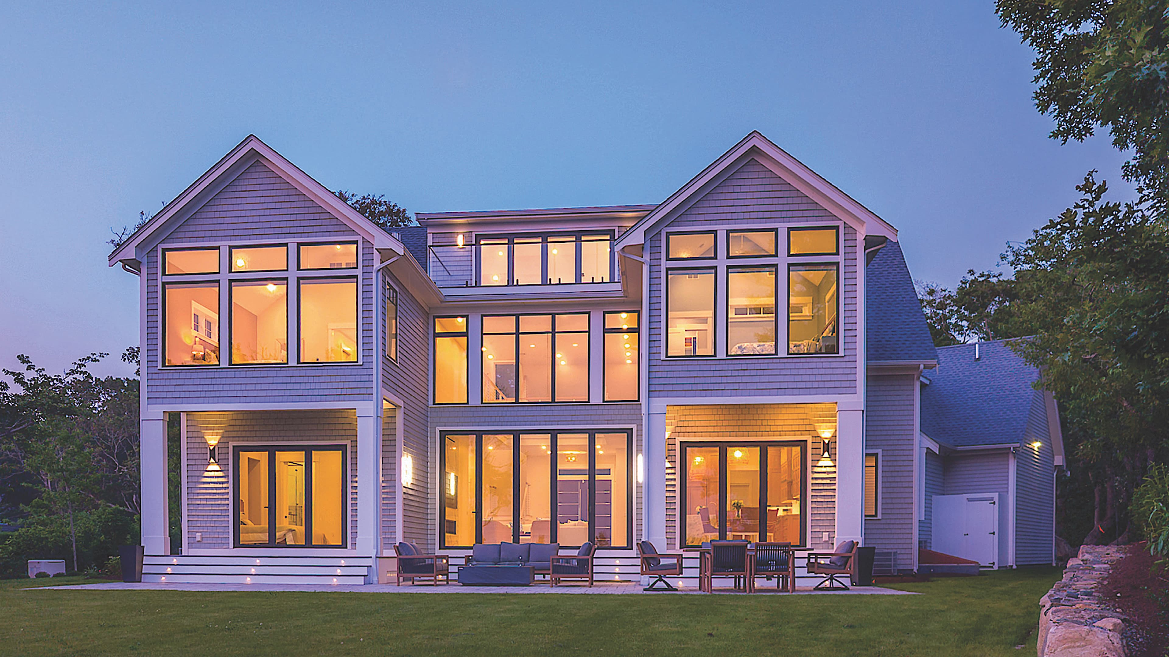 Custom wall of windows in a Longfellow home — engineered structural frame concealed within